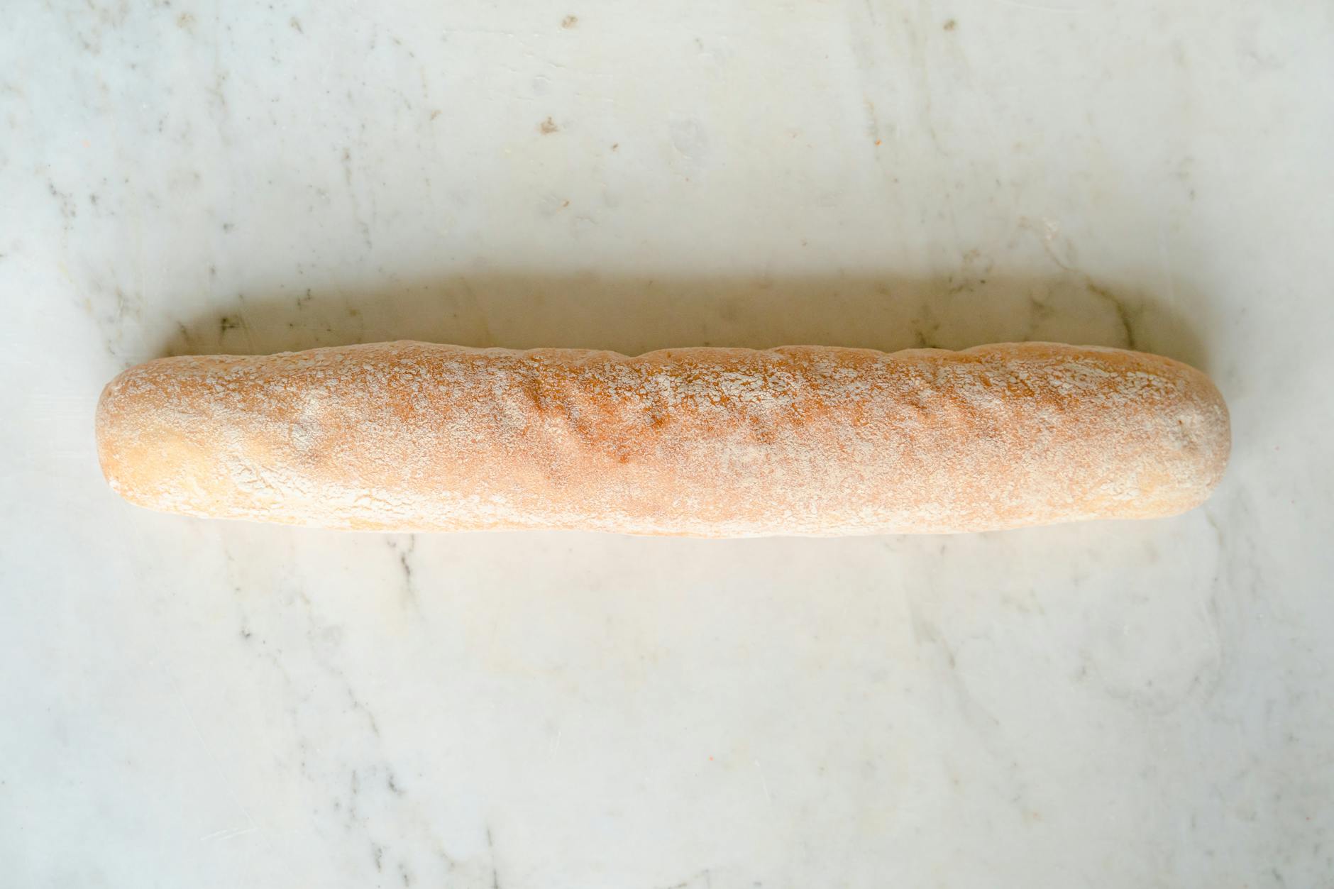 Świeżo upieczona ciabatta na jasnym, marmurowym blacie