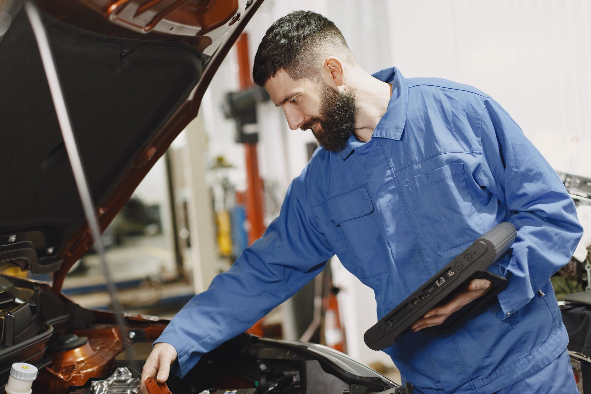 Mechanik sprawdza silnik używanego BMW w warsztacie